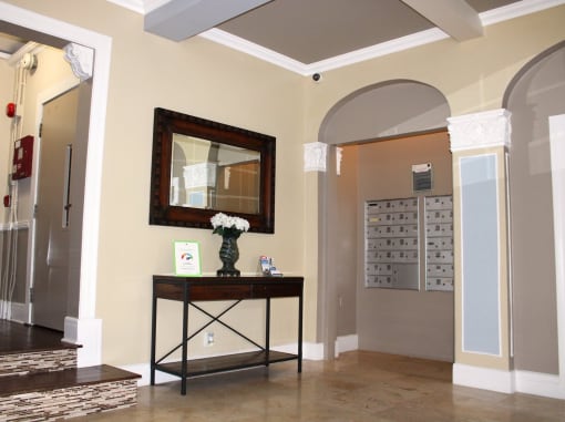 Pasadena Brookmore apartments lobby with tenant mailboxes and tall wall arches with decorative carved white trim.