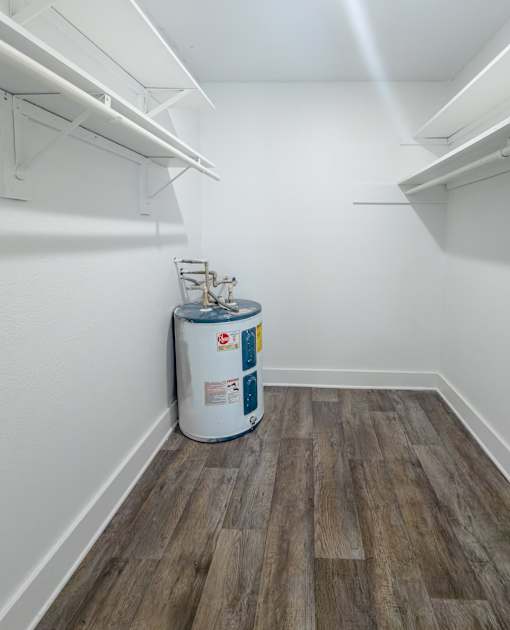 A large closet with wood flooring at Mandarin Bay Apartments.