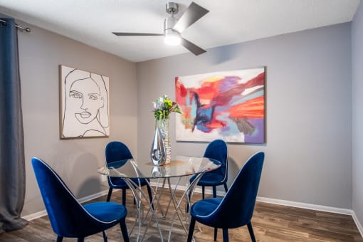 Apts in Arlington TX - dining room in Stadium 700 Apartments with table, modern chairs and artwork