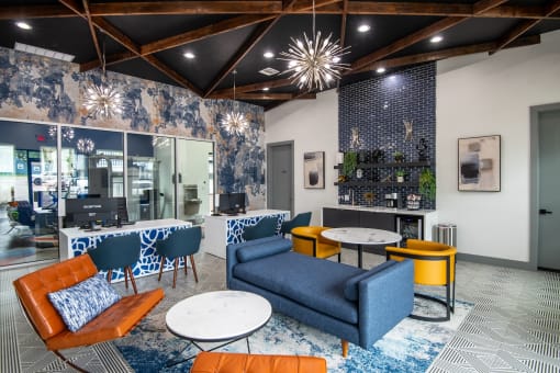 Inside leasing center at Stadium 700 Apartments in Arlington, TX with luxurious mid-century seating and a large leasing desk