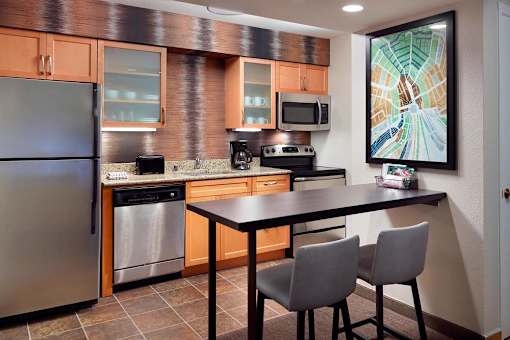 A kitchen with a refrigerator, oven, microwave, and dishwasher at Fusion Buckhead Apartments.