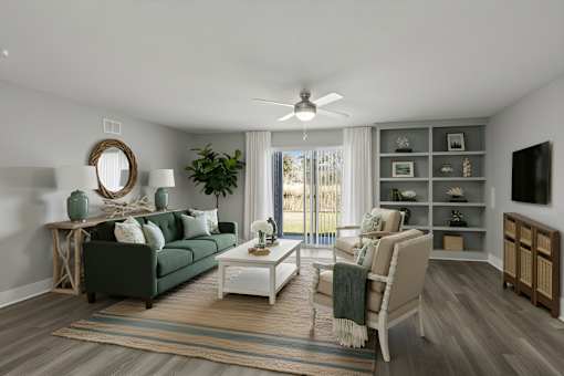 A living room with a green couch, a white coffee table, and a large window with a view of the outside at Mandarin Bay Apartments.