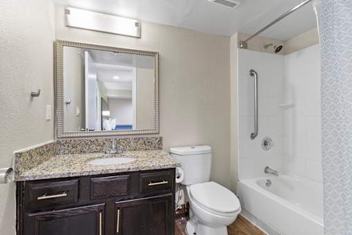 A bathroom with a sink, toilet, and bathtub at Fusion Orlando.