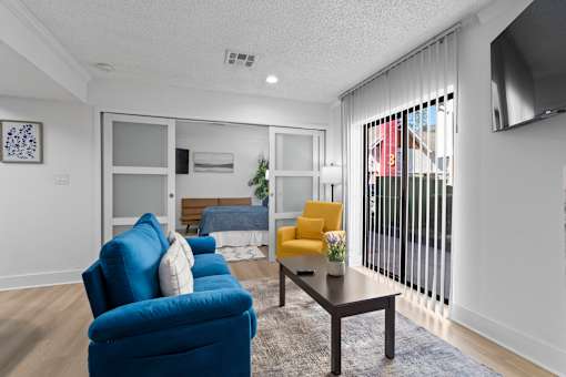 A living room with a blue chair and a yellow chair.
