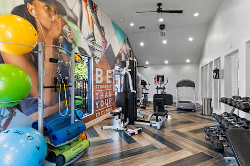 Fusion Orlando fitness center with a variety of equipment and a motivational poster on the wall.