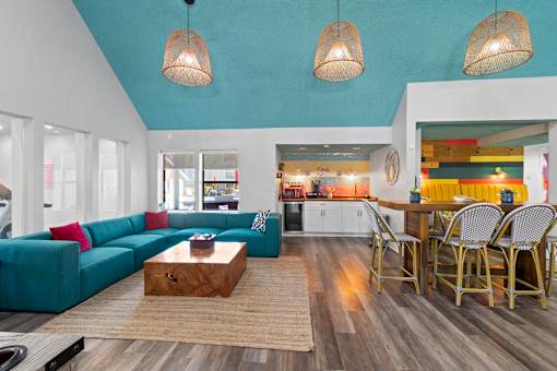 Fusion Orlando clubhouse with a blue couch and a wooden coffee table.