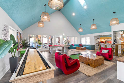 Fusion Orlando apartments clubhouse with a pool table and a red chair.