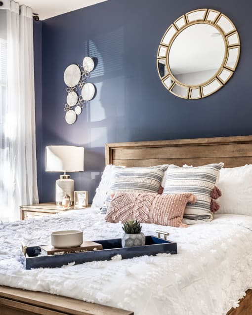 A bed in a bedroom with stylish decor at The Fort.
