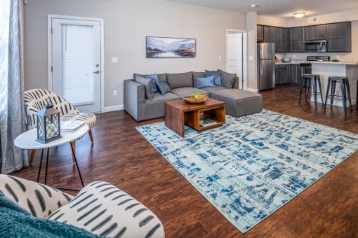Arbors at Turnberry pet friendly apartments and townhomes Pickerington, Ohio spacious living room with wood style flooring and natural light. Balcony and private attached garage.