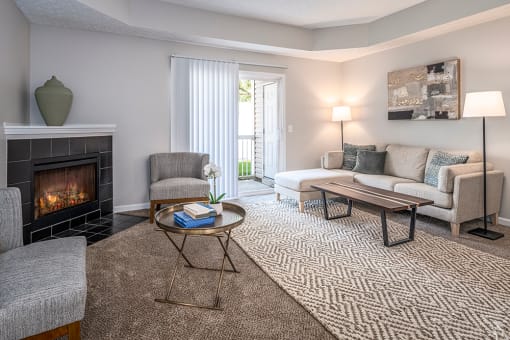 Arbors at Turnberry Apartments Pickerington Ohio Pet Friendly Updated Modern Interior spacious living room with carpet flooring, fireplace, natural light
