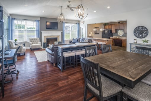 a living room and dining room with hardwood floors and a fireplace