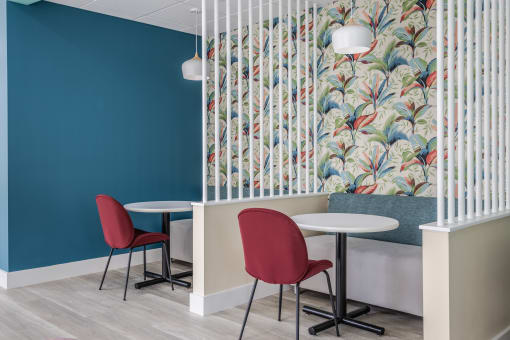 a room with blue walls and a colorful wallpaper on the wall