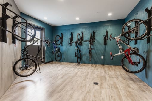 the bikes are hung up on the wall in the bike room