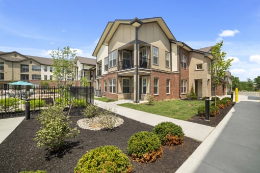 The exterior of Austin Park Apartments in Miamisburg, Ohio features attractive, well-lit landscaping and ample parking spaces for residents and guests.