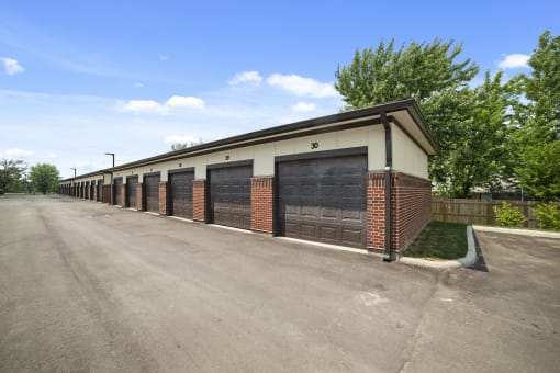 Studio apartments at Austin Park in Miamisburg, OH provide detached single-car parking garages accessible via an alleyway, surrounded by maintained landscaping.