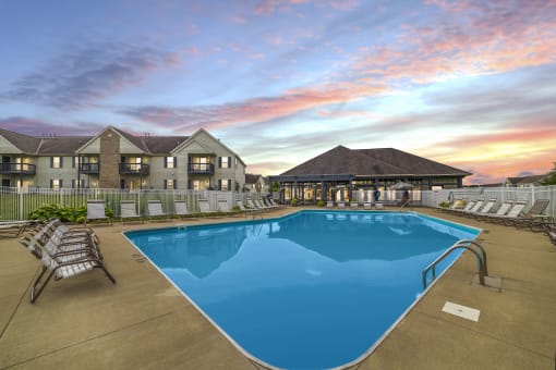 Resort-style swimming pool at Catalina Club Apartments in Pataskala, OH, complete with a spacious sundeck and lounge chairs.