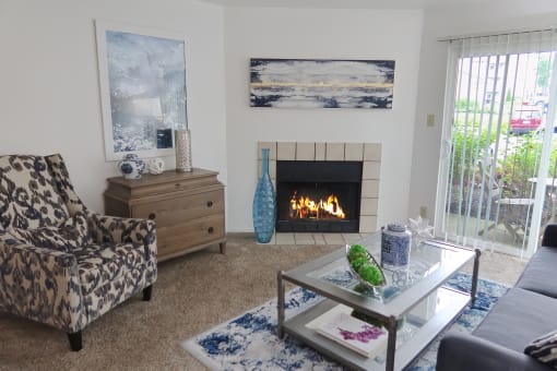 Pet-friendly apartment at The Boulevard in Florence, KY featuring a spacious living room with carpet flooring, high ceilings, and a sliding glass door to a private patio