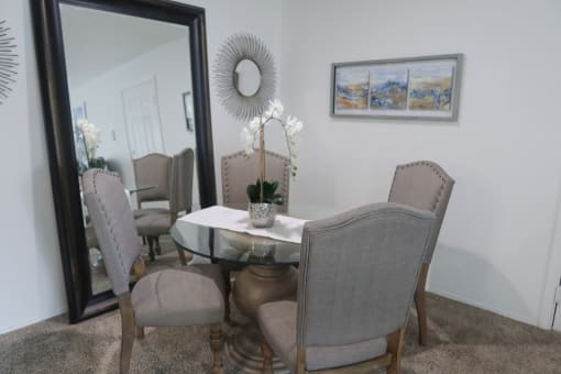 Elegant dining room with a large wall mirror and a table set for six