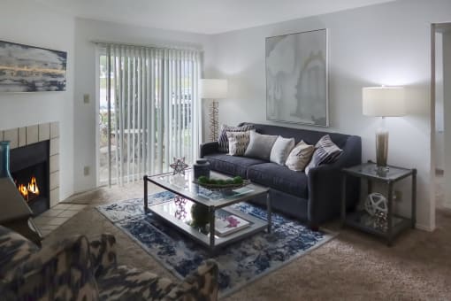 Cozy living room with a sofa, coffee table, and fireplace