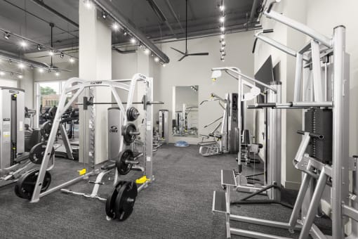 a photo of a fitness room with weights and cardio equipment