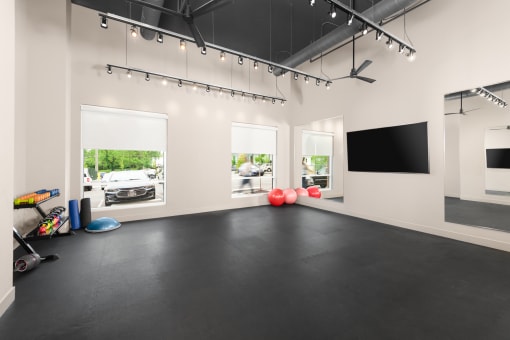 a large room with a black floor and a flat screen tv on the wall