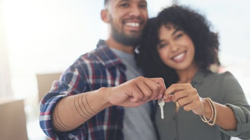 A man and woman holding keys together.