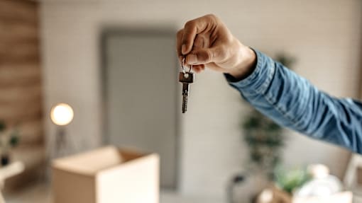 A person is holding a key in their hand.