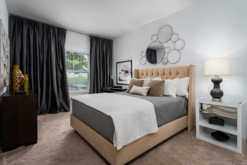 a bedroom with a bed and a nightstand in a 555 waverly unit