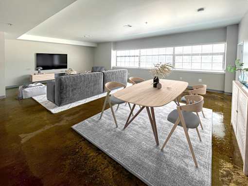 A modern living room with a grey rug and a wooden table.