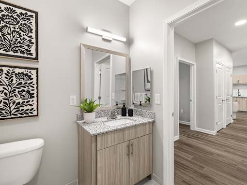 A bathroom with a tub, sink, and mirror.
