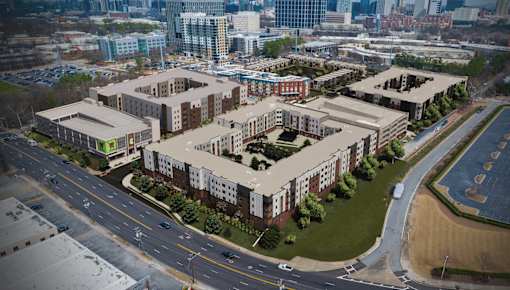 A large building complex with a parking lot in front.