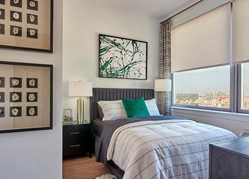 a bedroom with a bed and a large window
