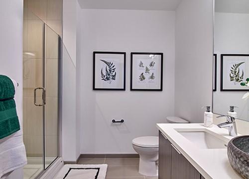 a bathroom with a toilet and a sink and a shower