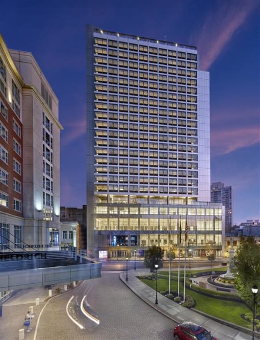 a tall building with a street in front of it at night