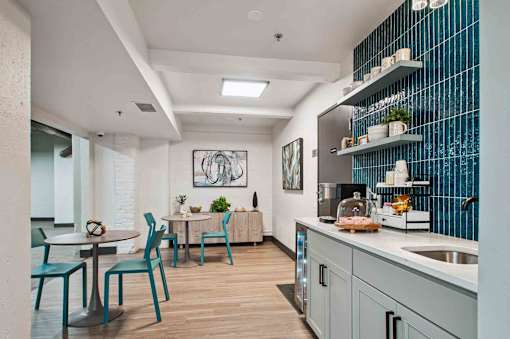 A kitchen with a dining table and chairs.