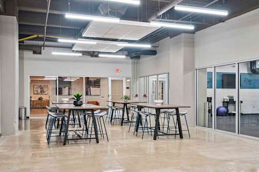 A modern office space with a dining area in the foreground.