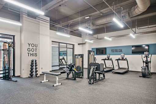 A gym with a sign that says "You got this" on the wall.