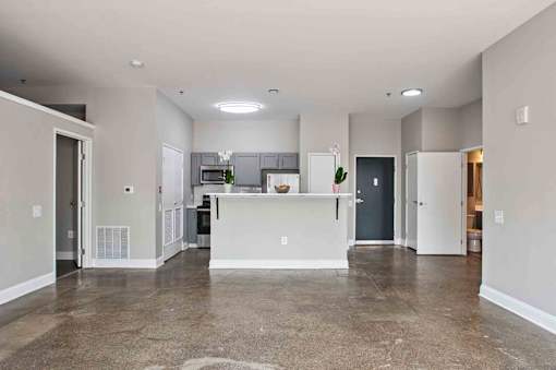 A spacious kitchen with a bar area in the middle.