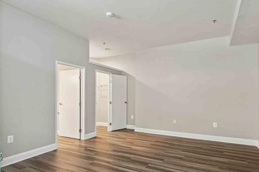 A room with wooden floors and white walls.