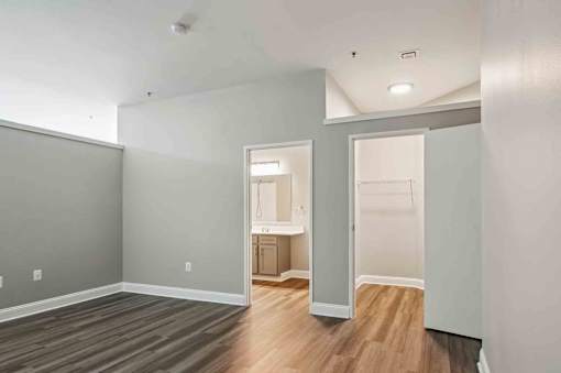 A room with a grey wall and a white door.