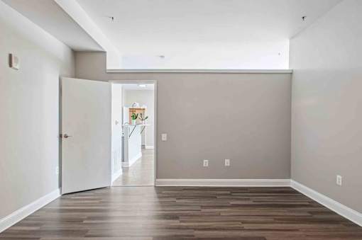 A room with a wooden floor and a white door.