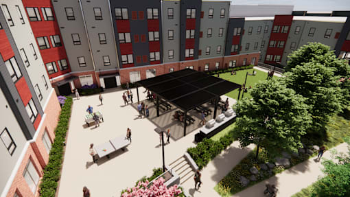 A courtyard with a black pavilion surrounded by red and grey buildings.