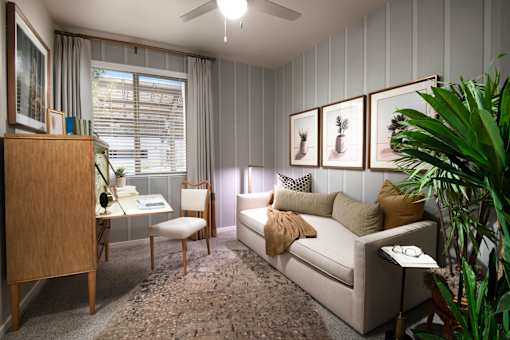 A living room with a couch, chair, and a cabinet.