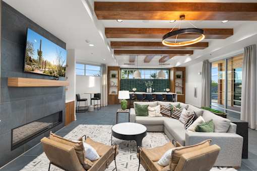 A modern living room with a fireplace and a flat screen TV mounted on the wall.