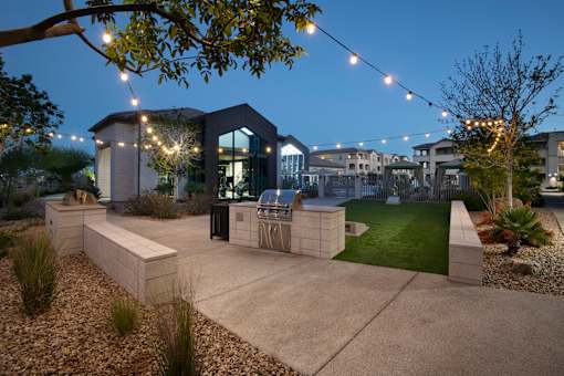 A modern house with a glass entrance and outdoor string lights.