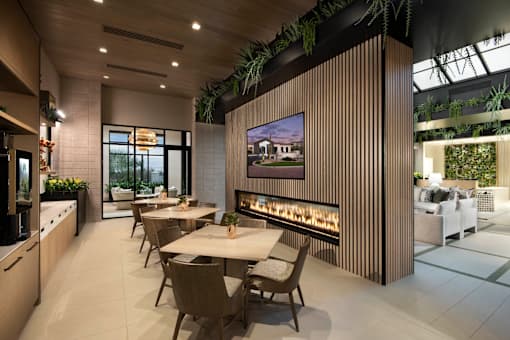 A modern dining room with a long table and chairs.