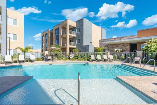 A swimming pool in front of a modern building.