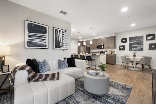 A modern living room with a white couch and a coffee table.