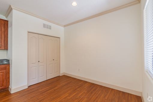 A room with a wooden floor and a white door.