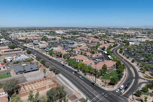 A road with cars and buildings on both sides.